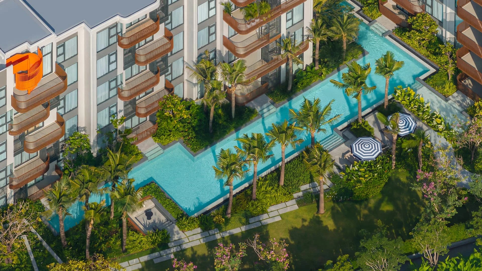 The lap pool and the sunbathing lawn between the buildings